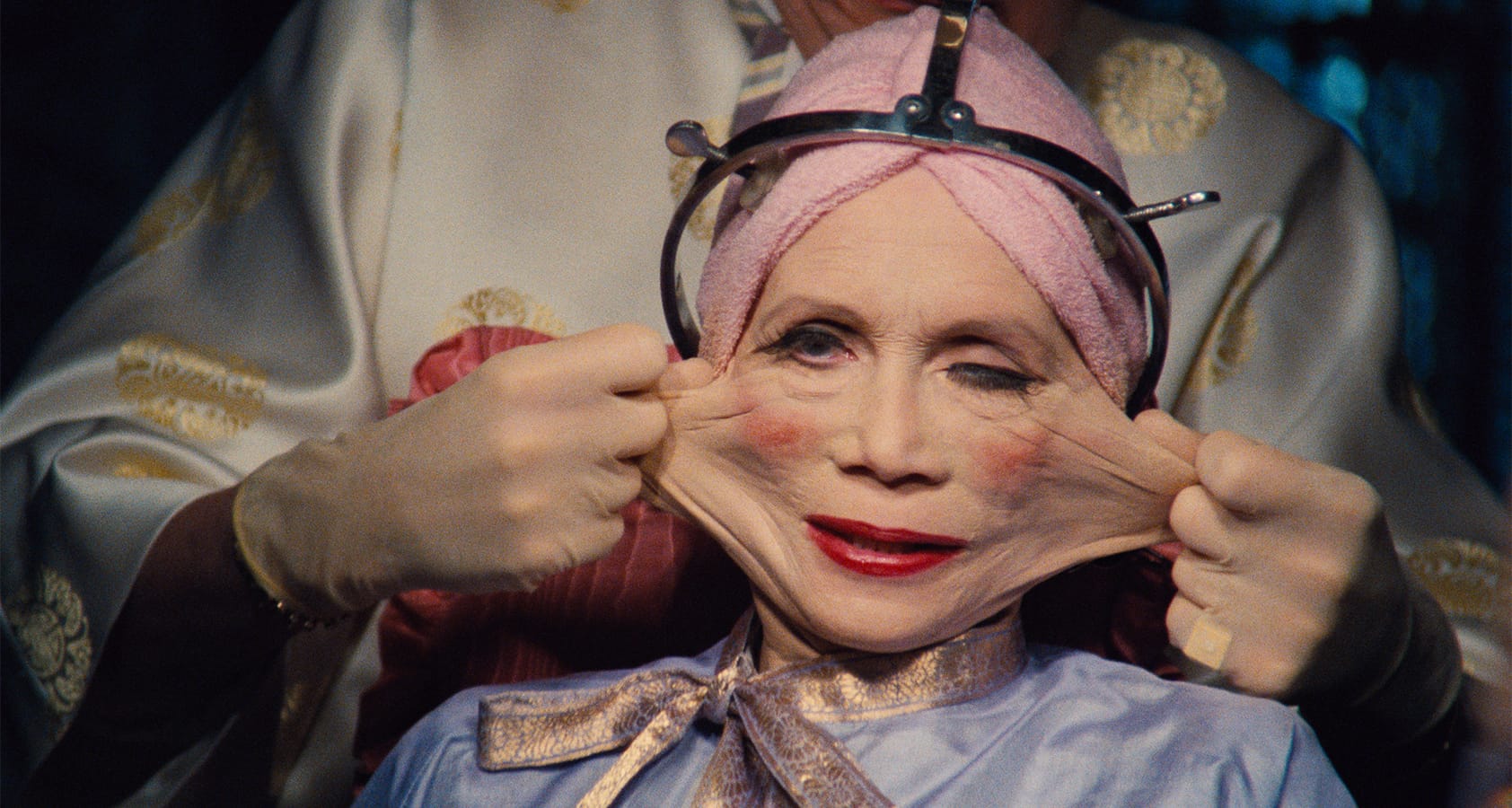 A scene from the film Brazil that shows a woman getting her face stretched